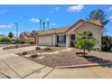 Well-maintained home with desert landscaping, and a spacious driveway, complemented by mature trees at 823 W Kyle Ct, Gilbert, AZ 85233