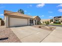 Single-story home with a two-car garage, desert landscaping, and a long driveway at 823 W Kyle Ct, Gilbert, AZ 85233