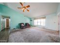 Comfortable living room with a fan, neutral walls and plush carpeting, perfect for relaxation at 8303 E Monterey Ave, Mesa, AZ 85209