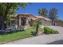 Charming home with a well-manicured lawn, mature trees, and a three-car garage at 9412 S Palm Dr, Tempe, AZ 85284