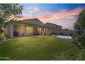 Expansive backyard featuring a lush lawn, covered patio, and a relaxing in-ground spa at 1145 E Winchester Pl, Chandler, AZ 85286
