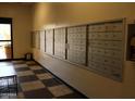 Mailboxes lined neatly along a wall in a well-lit entryway with tiled flooring at 12221 W Bell Rd # 363, Surprise, AZ 85378