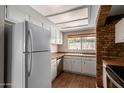 Bright kitchen featuring white appliances, wooden countertops, and ample natural light from above skylight at 137 W Wagoner Rd, Phoenix, AZ 85023