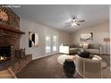 Staged living room featuring vaulted ceilings, a cozy fireplace, and comfortable seating at 137 W Wagoner Rd, Phoenix, AZ 85023