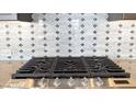 Modern gas cooktop with sleek backsplash and stainless steel knobs for precise temperature control at 16777 W Sheila Ln, Goodyear, AZ 85395