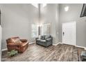 Bright living room features high ceilings, wood-look floors, neutral paint, and modern furnishings at 16917 W Sonora St, Goodyear, AZ 85338