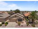 Charming single-Gathering home featuring a neutral color palette, well-manicured front yard, and an attached two-car garage at 18066 W Weatherby Dr, Surprise, AZ 85374