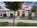 Inviting home featuring arched entryway, well-manicured shrubs, and beautiful desert landscaping at 19428 S 210Th Pl, Queen Creek, AZ 85142