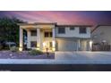 Two-story home boasts a three-car garage and grand entrance with elegant architectural details at 20139 N Bustos Way, Maricopa, AZ 85138