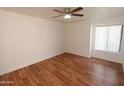 An empty bedroom shows wood floor and window with blinds at 2025 E Campbell Ave # 120, Phoenix, AZ 85016