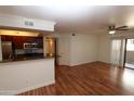Inviting living room featuring hardwood floors, a ceiling fan and access to the balcony at 2025 E Campbell Ave # 120, Phoenix, AZ 85016