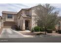 Beautiful two-story home with a two-car garage, well-maintained yard, and mature trees at 21050 E Munoz St, Queen Creek, AZ 85142