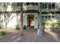 Welcoming front entrance with stone walkway, wood door and mature trees at 235 W Portland St, Phoenix, AZ 85003