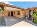 Inviting front entrance with a covered porch, brick facade, and a well-manicured garden at 2913 E Earll Dr, Phoenix, AZ 85016