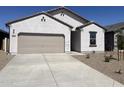 Single Gathering home featuring a two-car garage, a paved driveway, and desert landscaping at 29693 N Oak Dr, Florence, AZ 85132
