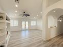 Open living room with recessed lighting, neutral walls, and bright natural light from the French doors at 30517 N Maple Chase Dr, San Tan Valley, AZ 85143