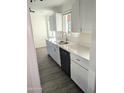 Bright kitchen featuring white cabinets, stainless steel sink, and modern countertops at 3421 W Montecito Ave, Phoenix, AZ 85017