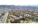 An aerial view showcases this neighborhood's well-maintained landscaping, desert surroundings, and proximity to mountain views at 3511 E Baseline Rd # 1098, Phoenix, AZ 85042