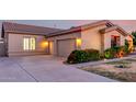 Charming home exterior featuring a multi-car garage, well-maintained lawn, and vibrant, colorful landscaping at 3531 E Norwood Cir, Mesa, AZ 85213