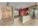Inviting foyer featuring travertine floors, double doors, and seamless flow into the adjacent living spaces at 3531 E Norwood Cir, Mesa, AZ 85213