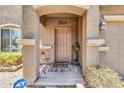 Inviting front porch with decorative accents, a stylish welcome sign, and cozy seating at 40638 N High Meadows Dr, San Tan Valley, AZ 85140