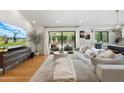 Bright living room featuring a large sectional sofa, hardwood floors, and sliding glass doors at 4842 E Fairmount Ave, Phoenix, AZ 85018