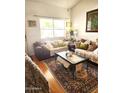 Comfortable living room with plush sofas, patterned rug, and ample natural light at 5136 E Evergreen St # 1053, Mesa, AZ 85205