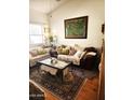 Cozy living room featuring a comfortable sofa and a large decorative painting at 5136 E Evergreen St # 1053, Mesa, AZ 85205