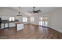 Open floor plan showcasing wood flooring, vaulted ceilings, lots of natural light and a modern kitchen at 705 W Country Estates Ave, Gilbert, AZ 85233