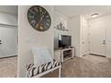 Open living area featuring neutral colors, comfortable seating, and a decorative wall clock at 7726 E Baseline Rd # 125, Mesa, AZ 85209