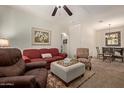 Relaxing living room with a ceiling fan, plush seating, and a decorative coffee table at 7726 E Baseline Rd # 125, Mesa, AZ 85209
