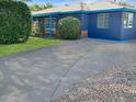 Exterior view of home showcasing the driveway, minimalist landscaping, and blue exterior paint at 846 E Ocotillo Rd, Phoenix, AZ 85014