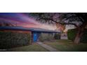 Charming single-story home with brick accents, blue trim, a manicured lawn, and mature landscaping at 846 E Ocotillo Rd, Phoenix, AZ 85014