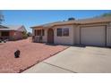 Charming single-story home with a simple front exterior and gravel landscaping at 10018 N 97Th Dr # A, Peoria, AZ 85345