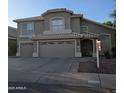 Charming two-story home with a three-car garage, landscaped front yard, and tile roof at 1032 E Sheffield Ave, Chandler, AZ 85225
