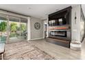 Open-concept living area with fireplace, entertainment center, and sliding door access to the backyard at 14481 W Via Del Oro --, Surprise, AZ 85379