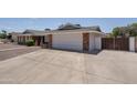 Home featuring brick accents and a spacious concrete driveway leading to the garage at 1541 E Glencove St, Mesa, AZ 85203