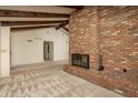Living room featuring brick fireplace and vaulted ceilings with exposed beams at 1541 E Glencove St, Mesa, AZ 85203