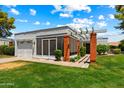 Inviting exterior of home featuring a well-manicured lawn and covered entryway at 156 Leisure World --, Mesa, AZ 85206