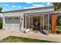 Home exterior showing a two-car garage, gated entry and well kept lawn at 156 Leisure World --, Mesa, AZ 85206