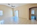 Spacious living room featuring tile floors, vaulted ceiling, and sliding glass door at 1630 W Pecan Rd, Phoenix, AZ 85041
