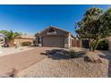 Charming single-story home featuring a brick driveway and low-maintenance desert landscaping at 18297 W Spencer Dr, Surprise, AZ 85374
