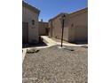 Exterior view of two beige homes with desert landscaping and a shared walkway at 18650 N 91St Ave # 1501, Peoria, AZ 85382