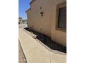 Side view of home featuring low-water landscaping and desert plants at 18650 N 91St Ave # 1501, Peoria, AZ 85382
