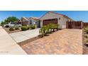 Charming single-story home features a well-maintained front yard with a two car garage and a tiled roof at 18669 W Vista Norte St, Goodyear, AZ 85338