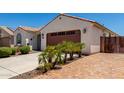 Charming single-story home features a well-maintained front yard with a two car garage and a tiled roof at 18669 W Vista Norte St, Goodyear, AZ 85338