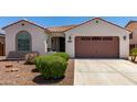 Charming single-story home features a well-maintained front yard with a two car garage and a tiled roof at 18669 W Vista Norte St, Goodyear, AZ 85338