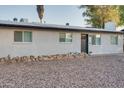 Exterior view with low-maintenance landscaping, dark trim, and a gray front door at 217 E Bruce Ave, Gilbert, AZ 85234