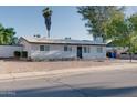 A view of the front of the house with low maintenance landscaping, sidewalk, and driveway at 217 E Bruce Ave, Gilbert, AZ 85234