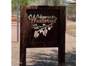 A decorative 'Welcome to Westwood' sign featuring artistic olive branches, creating a warm and inviting community entrance at 2221 W Mitchell Dr, Phoenix, AZ 85015